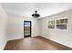 Light bedroom featuring wood floors and a black-framed glass door at 17524 Seidner Rd, Winter Garden, FL 34787