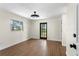 Light bedroom featuring wood floors and a black-framed glass door at 17524 Seidner Rd, Winter Garden, FL 34787