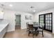 Cozy dining area with round table, stylish chairs, and access to the outdoor patio at 17524 Seidner Rd, Winter Garden, FL 34787