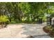 Long driveway leads to a gated area, surrounded by lush greenery and mature trees at 17524 Seidner Rd, Winter Garden, FL 34787