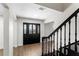 Welcoming foyer features wood floors, elegant staircase, and a stylish front door, creating a warm first impression at 17524 Seidner Rd, Winter Garden, FL 34787