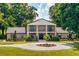 Elegant brick home showcasing a classic design, mature landscaping, and a welcoming circular driveway at 17524 Seidner Rd, Winter Garden, FL 34787