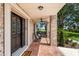 Charming front porch with brick details, ceiling fan, and a welcoming entryway, perfect for enjoying the outdoors at 17524 Seidner Rd, Winter Garden, FL 34787