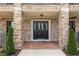 Inviting front porch with brick columns, decorative door, and charming landscaping, perfect for a warm welcome at 17524 Seidner Rd, Winter Garden, FL 34787