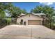 Two car garage with a spacious driveway, enclosed by a black metal fence at 17524 Seidner Rd, Winter Garden, FL 34787