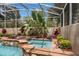 Screened in pool with hot tub, waterfall, tropical landscaping and flagstone decking at 17524 Seidner Rd, Winter Garden, FL 34787