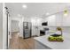 Bright kitchen with white cabinets, stainless steel refrigerator, and eat-in island at 17524 Seidner Rd, Winter Garden, FL 34787