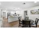 Open concept kitchen and dining area with modern white cabinets and stainless steel appliances at 17524 Seidner Rd, Winter Garden, FL 34787