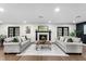 Bright living room featuring a fireplace, comfortable sofas, and stylish decor at 17524 Seidner Rd, Winter Garden, FL 34787