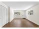 Bright living room with wood floors, two windows, and white door at 17524 Seidner Rd, Winter Garden, FL 34787