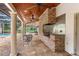 Back patio with brick outdoor grill, flagstone flooring, and screened-in porch with a swimming pool at 17524 Seidner Rd, Winter Garden, FL 34787