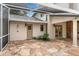 Back patio with flagstone flooring, stucco walls, and entry doors to the home at 17524 Seidner Rd, Winter Garden, FL 34787