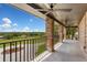 Spacious porch with brick columns overlooking the green fields and a sunny blue sky at 17524 Seidner Rd, Winter Garden, FL 34787
