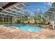 Screened in pool with flagstone decking and tropical landscaping at 17524 Seidner Rd, Winter Garden, FL 34787