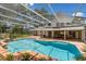 Screened in pool with flagstone decking and tropical landscaping leading to the residence at 17524 Seidner Rd, Winter Garden, FL 34787