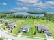 Gorgeous aerial view of a sprawling lot with lake access and a beautifully landscaped home with room for a pool at 17537 Sailfin Dr, Orlando, FL 32820