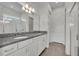 Bathroom featuring double sinks, granite countertops, and a glass-enclosed shower at 17537 Sailfin Dr, Orlando, FL 32820