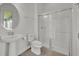Bathroom boasts a pedestal sink and walk-in shower with glass door at 17537 Sailfin Dr, Orlando, FL 32820
