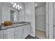 Well-lit bathroom featuring granite countertops, a linen cabinet, and a walk-in closet at 17537 Sailfin Dr, Orlando, FL 32820