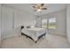 Bright bedroom features a ceiling fan, neutral carpeting, and sun-filled windows at 17537 Sailfin Dr, Orlando, FL 32820