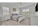Bright bedroom featuring neutral colors, a ceiling fan, and natural light through large windows at 17537 Sailfin Dr, Orlando, FL 32820