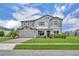 Beautiful two-story home with a well-manicured lawn, an attached two-car garage, and a charming covered entryway at 17537 Sailfin Dr, Orlando, FL 32820