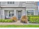 Inviting front entrance featuring decorative plants, a charming porch, and a neatly brick-paved walkway at 17537 Sailfin Dr, Orlando, FL 32820