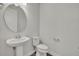 Simple half bathroom with a pedestal sink and modern toilet, perfect for guests at 17537 Sailfin Dr, Orlando, FL 32820