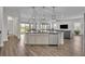 Kitchen island with stainless steel dishwasher opens to dining and living areas at 17537 Sailfin Dr, Orlando, FL 32820