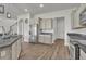 Bright kitchen features stainless steel refrigerator, granite countertops, and wood-look floors at 17537 Sailfin Dr, Orlando, FL 32820