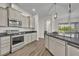 Modern kitchen showcases granite counters, stainless appliances, and wood-look flooring at 17537 Sailfin Dr, Orlando, FL 32820