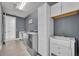 Laundry room features a utility sink with shaker cabinets and gray accent wall at 17537 Sailfin Dr, Orlando, FL 32820