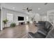 Bright living room with wood floors, plenty of natural light, and a comfortable seating arrangement for relaxation and entertainment at 17537 Sailfin Dr, Orlando, FL 32820