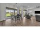 Dining area leads to living room with outdoor views through sliding glass doors at 17537 Sailfin Dr, Orlando, FL 32820