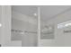 Shower featuring glass enclosure, white tile, and decorative accent tiles at 17537 Sailfin Dr, Orlando, FL 32820