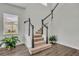 Staircase with white railings, black accents, and wood-look flooring at 17537 Sailfin Dr, Orlando, FL 32820