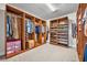 Spacious walk-in closet featuring wood shelving and ample storage space for clothes and shoes at 17537 Sailfin Dr, Orlando, FL 32820