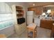 Kitchen boasts natural light, oak cabinets, white appliances, and a functional layout perfect for cooking at 1754 Torrington Cir, Longwood, FL 32750