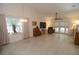 Inviting living room with high ceilings, tile floors, a ceiling fan, and access to the outdoors through sliding doors at 1754 Torrington Cir, Longwood, FL 32750