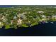 Aerial view of a community along a tranquil lake with docks and waterfront properties at 181 W Minnehaha Ave, Clermont, FL 34711