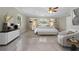 Serene main bedroom with neutral decor, tile flooring, and natural light from the windows at 181 W Minnehaha Ave, Clermont, FL 34711
