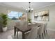 Elegant dining room with neutral paint and large window and elegant table set at 181 W Minnehaha Ave, Clermont, FL 34711