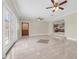 Open-concept living space with tile flooring, stylish decor, and a seamless transition to the kitchen at 181 W Minnehaha Ave, Clermont, FL 34711