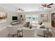 Comfortable living room with white furniture, tile floors, and access to the yard through French doors at 181 W Minnehaha Ave, Clermont, FL 34711