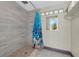 Tiled shower with modern fixtures, a view to the outside, and a unique design at 181 W Minnehaha Ave, Clermont, FL 34711