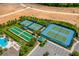 Aerial view of community amenities featuring tennis courts, bocce ball, and pool with ample parking at 2156 Antilles Club Dr, Kissimmee, FL 34747