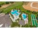 Aerial view of the community pool and amenity area, featuring palm trees, lounge chairs, and well-maintained grounds at 2156 Antilles Club Dr, Kissimmee, FL 34747