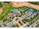 Community aerial view featuring a clubhouse, pool, tennis courts, and landscaped grounds, showcasing the available amenities at 2156 Antilles Club Dr, Kissimmee, FL 34747
