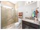 Bathroom with walk-in shower, granite countertop, and built-in shelving at 2156 Antilles Club Dr, Kissimmee, FL 34747