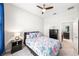 Cozy bedroom with bed, side tables, and view into a bathroom at 2156 Antilles Club Dr, Kissimmee, FL 34747